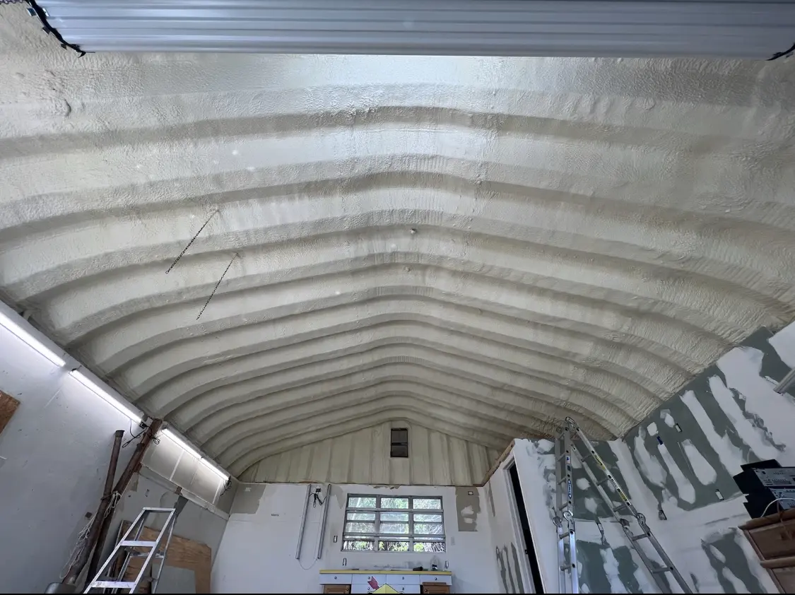 Spray polyurethane foam applied to the underside of a metal roof deck in Hingham